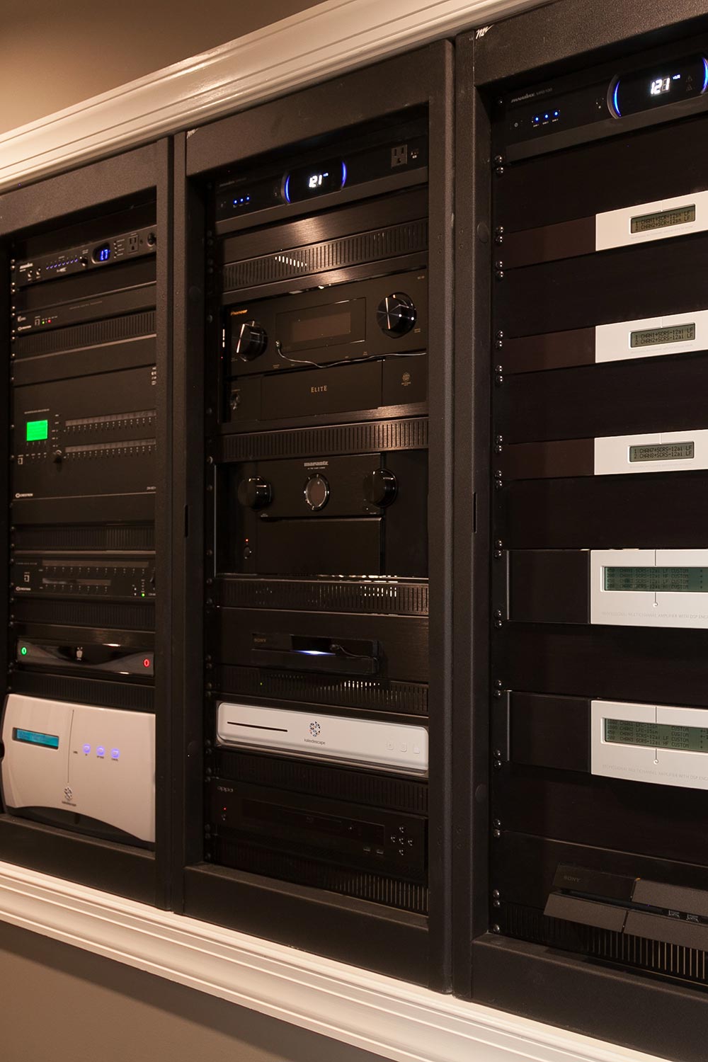 Close-up of professional AV equipment racks stacked with components and receivers