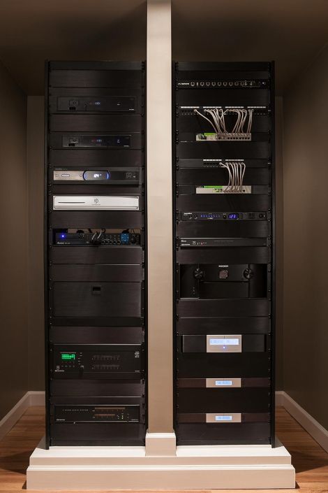 Professional dual electronic equipment racks filled with black audio-visual components