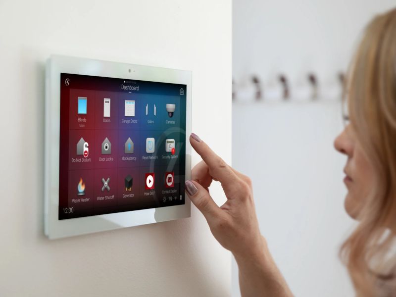 Control4 Touch panel in a able with a traditional home in the background
